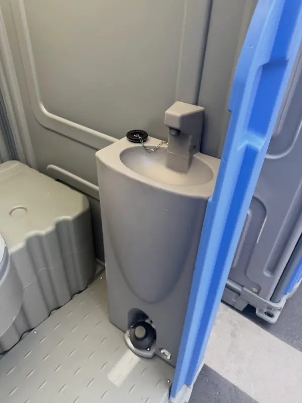 Foot-pump sink inside a deluxe portable toilet