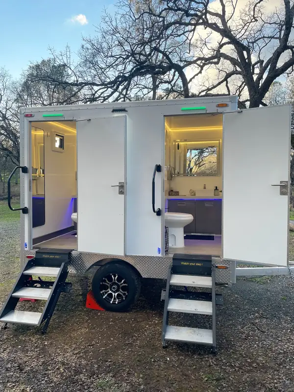 Two-stall luxury restroom trailer with both doors open